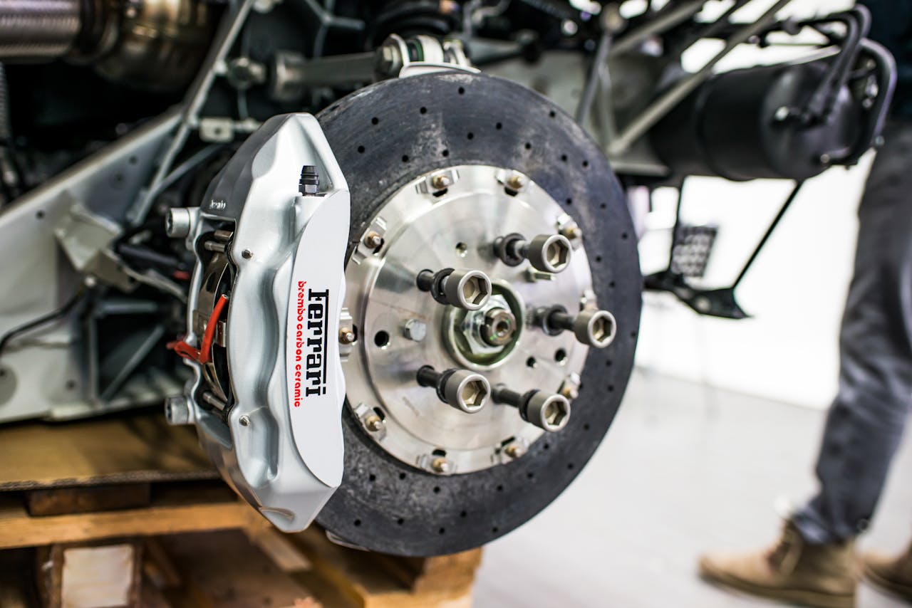 services-img-03 Detailed view of disc brake and caliper on a high-performance car, emphasizing precision and technology.